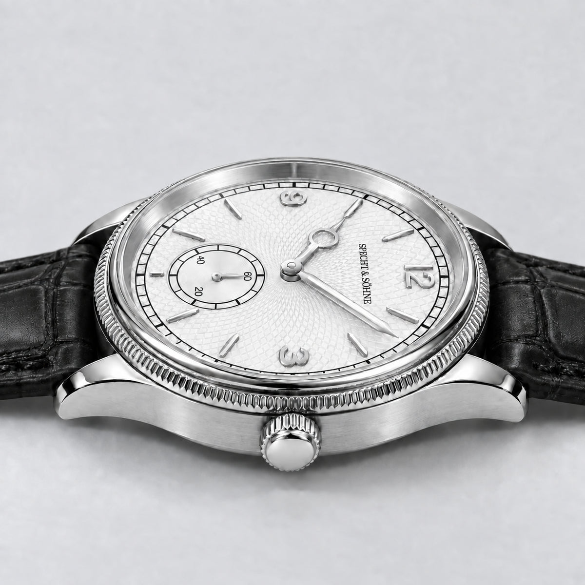 Specht & Söhne Invictus 1986 White: vista lateral da caixa e coroa prateadas, mostrador branco e pulseira preta.